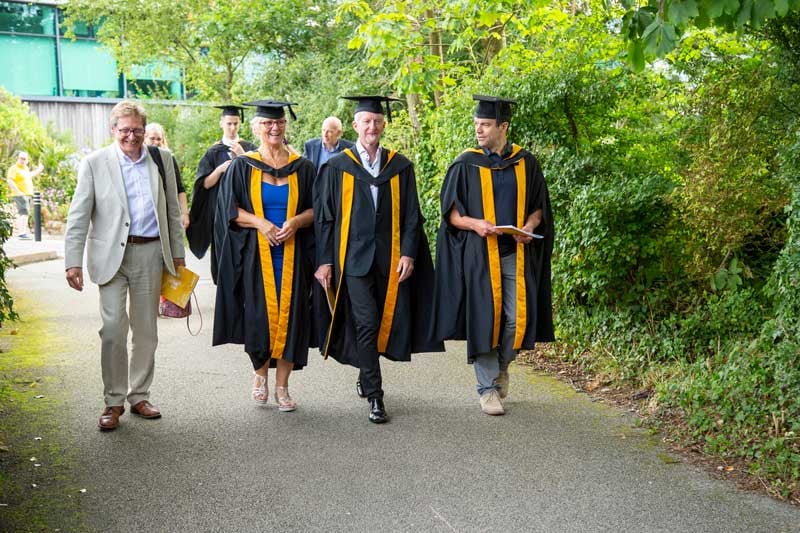 Falmouth graduates walking on-campus