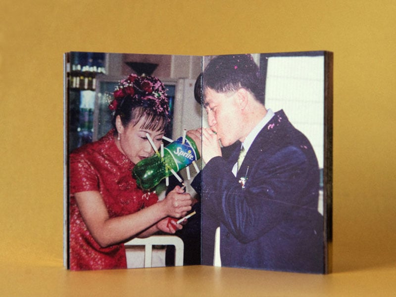 Extract from Beijing Silvermine photobook - Two Chinese people smoking cigarettes through an empty plastic bottle