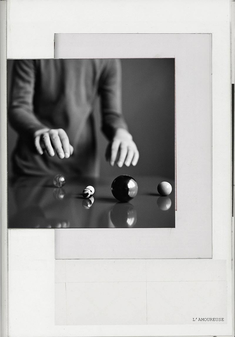 L’Amoureuse photobook cover by Anne de Gelas - Black and white image of a womans' hands touching marbles