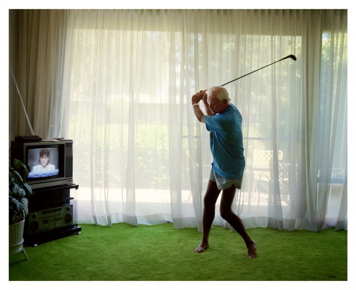 Larry Sultan Photography - elderly man swinging golf club in living room