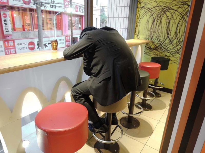 Man slumped over table in McDonalds restaurant