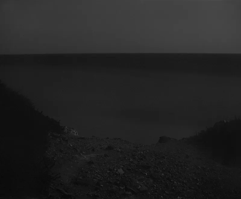 Photo by Awoiska Van Der Molen showing dark rocky landscape