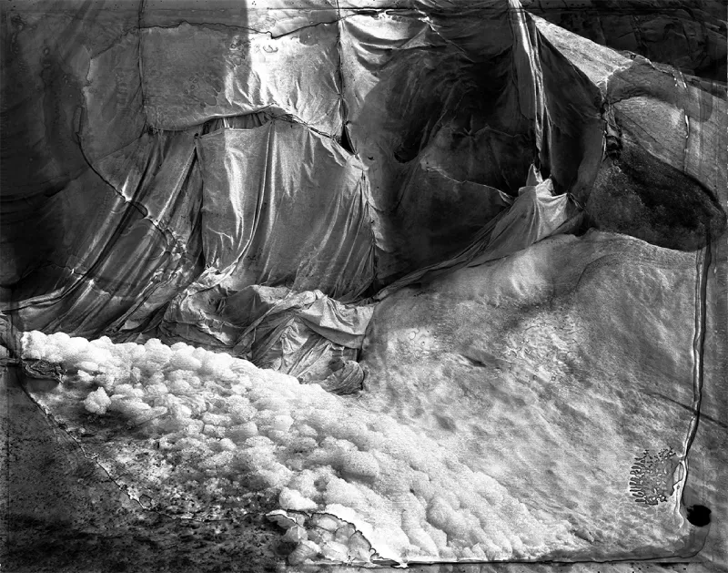 Photograph by Esther Vonplon showing crumpled sheets pieced together on top of snow and ice