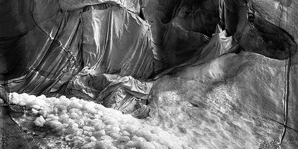 Photograph by Esther Vonplon showing crumpled sheets pieced together on top of snow and ice